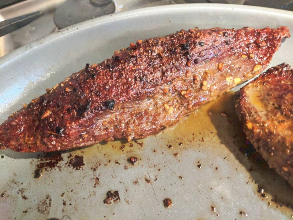 The classic steakhouse cooking method calls for a raw steak to be seared on each side for 3-6 minutes before it's finished in a 450 f oven until the inside reaches the desired doneness. Fatty cuts typically stay juicy during this cooking process since fat does not evaporate, but lean cuts, on the other hand,